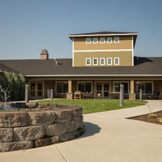 A modern community building with landscaped grounds.