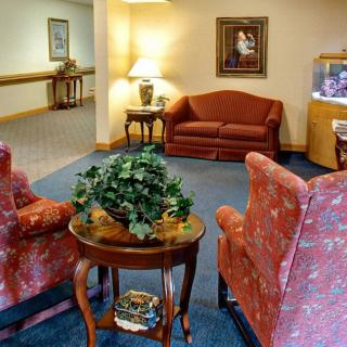 A cozy lobby area with sofas, armchairs, a coffee table, and decorative elements.