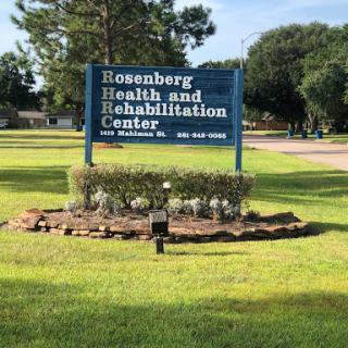 Sign for Rosenberg Health and Rehabilitation Center surrounded by landscaped area.