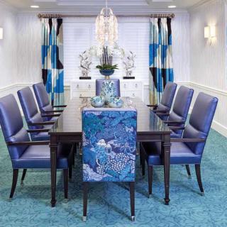 A modern dining room with blue chairs and elegant decor.