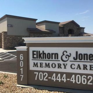 A signage for Elkhorn & Jones Memory Care in front of the facility building.