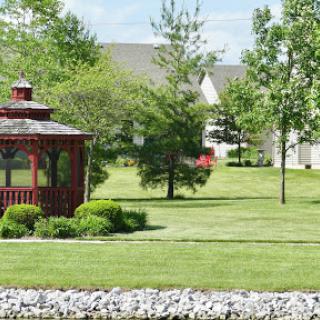 A serene park featuring a charming gazebo surrounded by lush greenery.