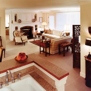 A spacious and elegantly designed living room with a cozy fireplace and comfortable seating.