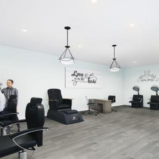A modern salon interior with stylish chairs and lighting fixtures.