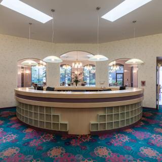 An elegant reception desk with stylish lighting in a hotel lobby.