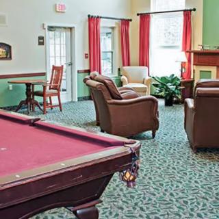 A cozy game room featuring a pool table and comfortable seating arrangements.