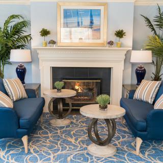 Elegant living room with a fireplace and blue-themed decor.