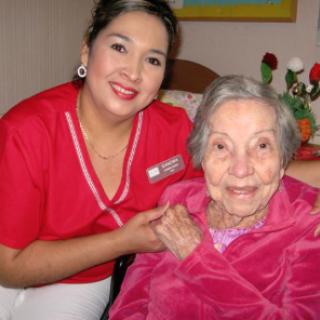 A caregiver and an elderly woman share a warm moment together, showcasing the bond of companionship in healthcare.