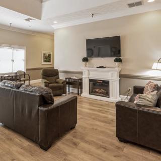 A cozy living room with a fireplace and comfortable seating arrangement.