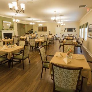 A spacious dining room with arranged tables and elegant decor.