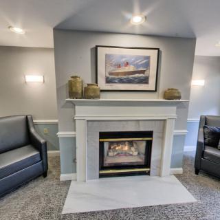 A modern living room with a cozy fireplace and comfortable seating.