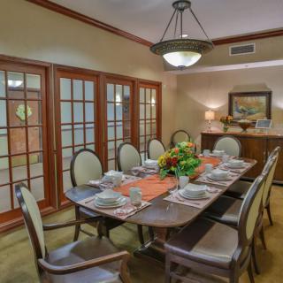 A beautifully set dining room table with elegant decor and warm lighting.