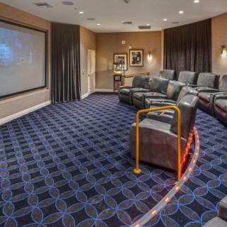 A luxurious home theater setup with comfortable seating and a large projector screen.