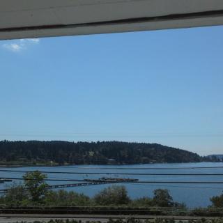 A serene view of an island and water under a clear blue sky.