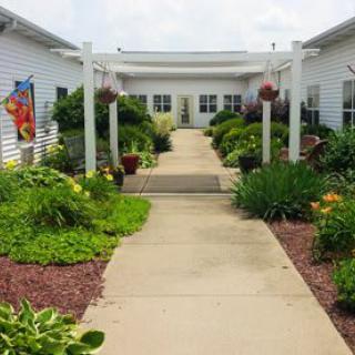 A beautifully landscaped garden walkway leading to a building entrance.