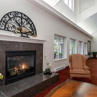A cozy living room with a modern fireplace and comfortable seating.