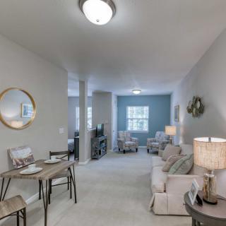 A modern and cozy living room with neutral tones and stylish furniture.