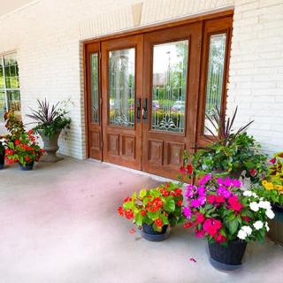 A welcoming porch with vibrant potted flowers adorning the entrance.