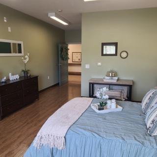 A modern minimalist bedroom with a neatly made bed and stylish decor.