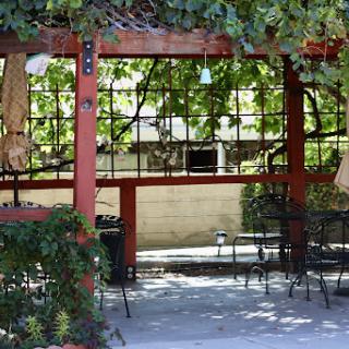 A cozy outdoor dining area adorned with greenery, perfect for relaxing meals.