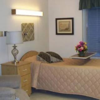 A cozy bedroom with a single bed, nightstand, and decorative elements.