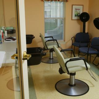 An interior view of a hair salon with styling chairs and equipment.