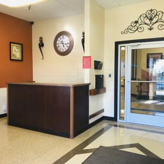 A welcoming lobby area featuring a reception desk and decorative wall clock.