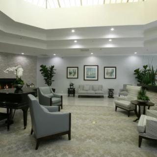 A modern lobby with stylish seating, elegant lighting, and decorative plants.
