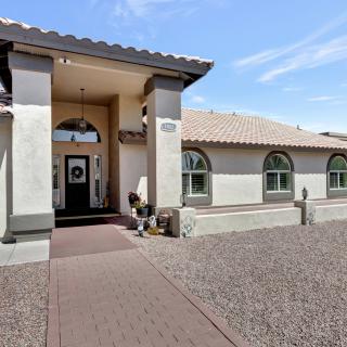 A modern residential house with an arched entrance and tiled roof.