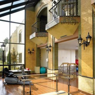 A modern interior space with therapy equipment and a glass ceiling.