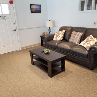 A cozy living room setup featuring a comfortable sofa with decorative pillows and a stylish coffee table.