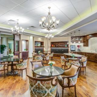 An elegant dining area with luxurious furnishings and chandeliers.