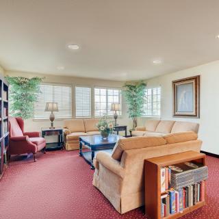 A cozy living room with comfortable seating, bookshelves, and decor.