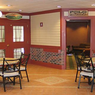 Interior view of a pizza-themed restaurant with tables and chairs.