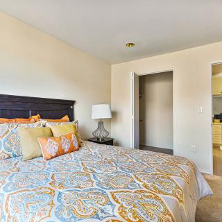 A cozy bedroom with patterned bedding and elegant decor.