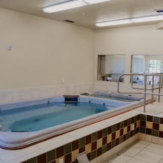 An indoor therapy pool with tiled flooring, designed for rehabilitation and hydrotherapy.