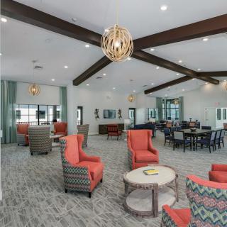 A modern lounge with vibrant seating and elegant chandeliers.
