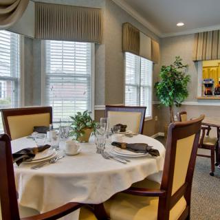 An elegant dining room with a beautifully set table and tasteful decor.
