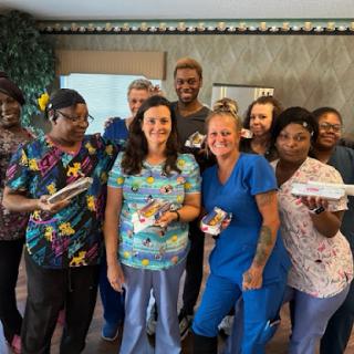 A joyful moment shared by a dedicated healthcare team celebrating together.