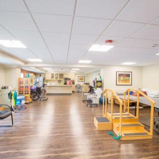 A spacious rehabilitation and therapy room equipped with exercise tools for physical therapy.