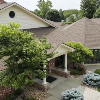 A residential house with landscaped surroundings and a front entrance.