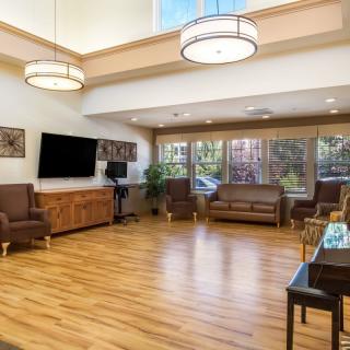 A spacious living room with modern furniture and large windows.
