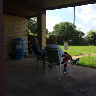 Two individuals enjoying a peaceful moment outdoors on a sunny day.