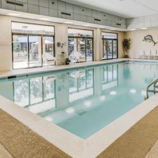 Indoor swimming pool area with large windows and modern design.
