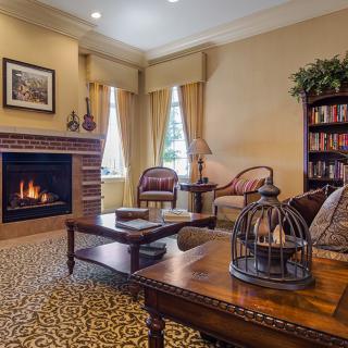 A cozy living room with a warm fireplace and traditional decor.
