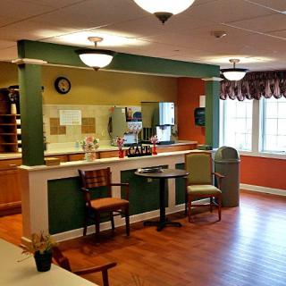 Cozy interior of a small cafe with a counter and seating area.