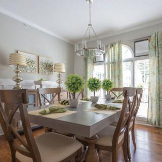 A bright dining room with elegant decor and a large window letting in natural light.