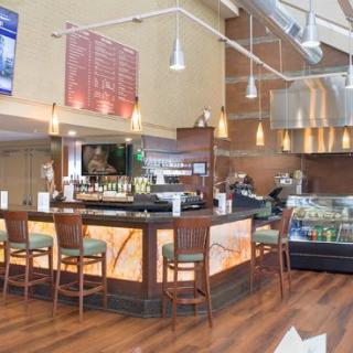 Modern bar and restaurant interior with stylish seating and lighting.