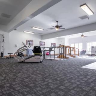 A spacious gym with various exercise equipment.