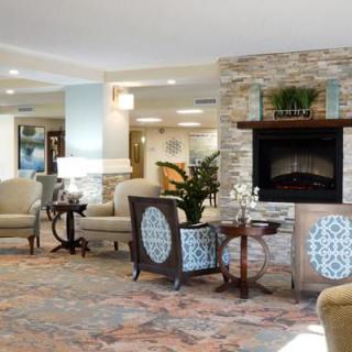 A cozy living room with elegant furniture and a stone fireplace.